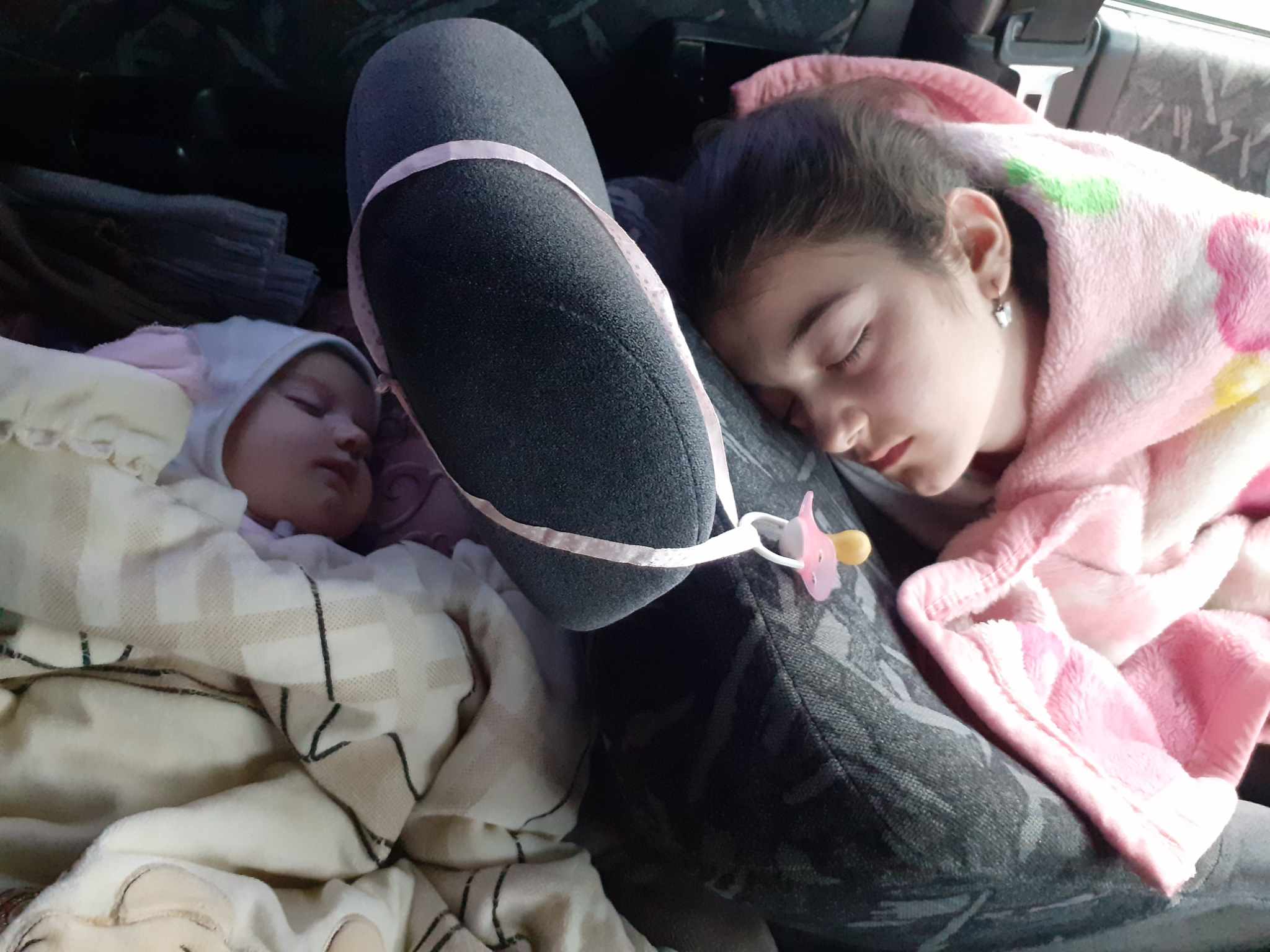 Mileta's children sleeping in car