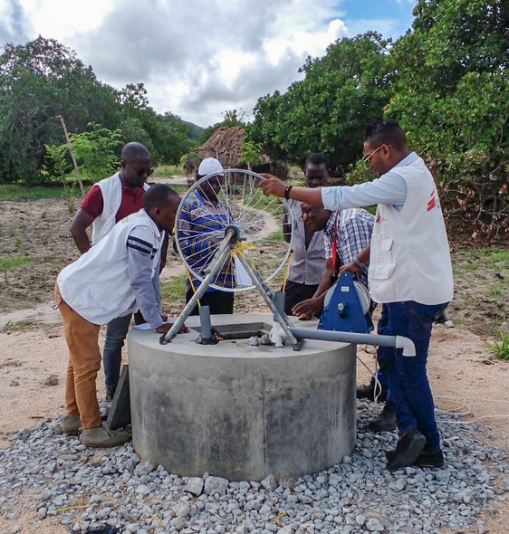 View of the MSF team checking one of the safeguarded wells equipped with hand pump systems built by MSF to facilitate access to water for the communities.
