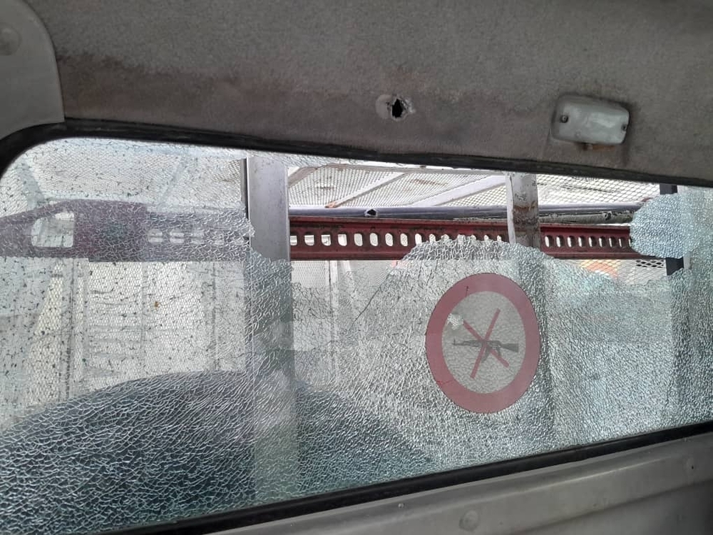 Shattered windscreen and gunshot hole
