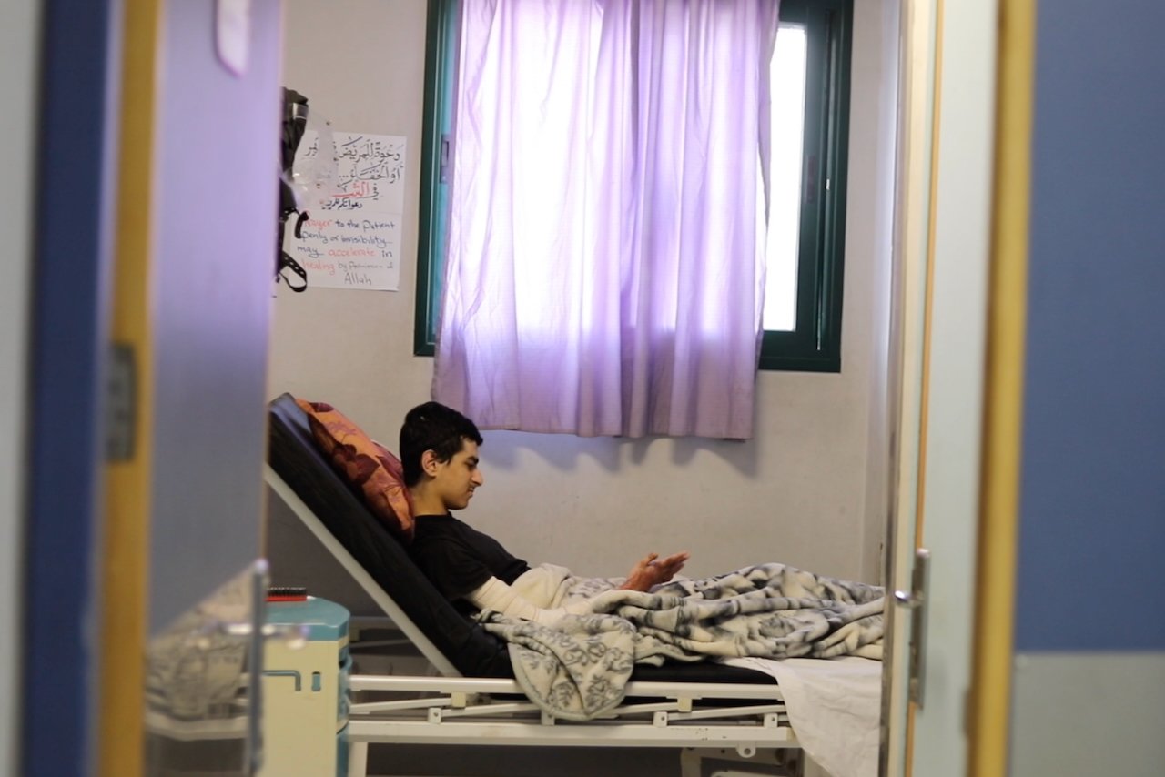 Teen burn patient in hospital bed