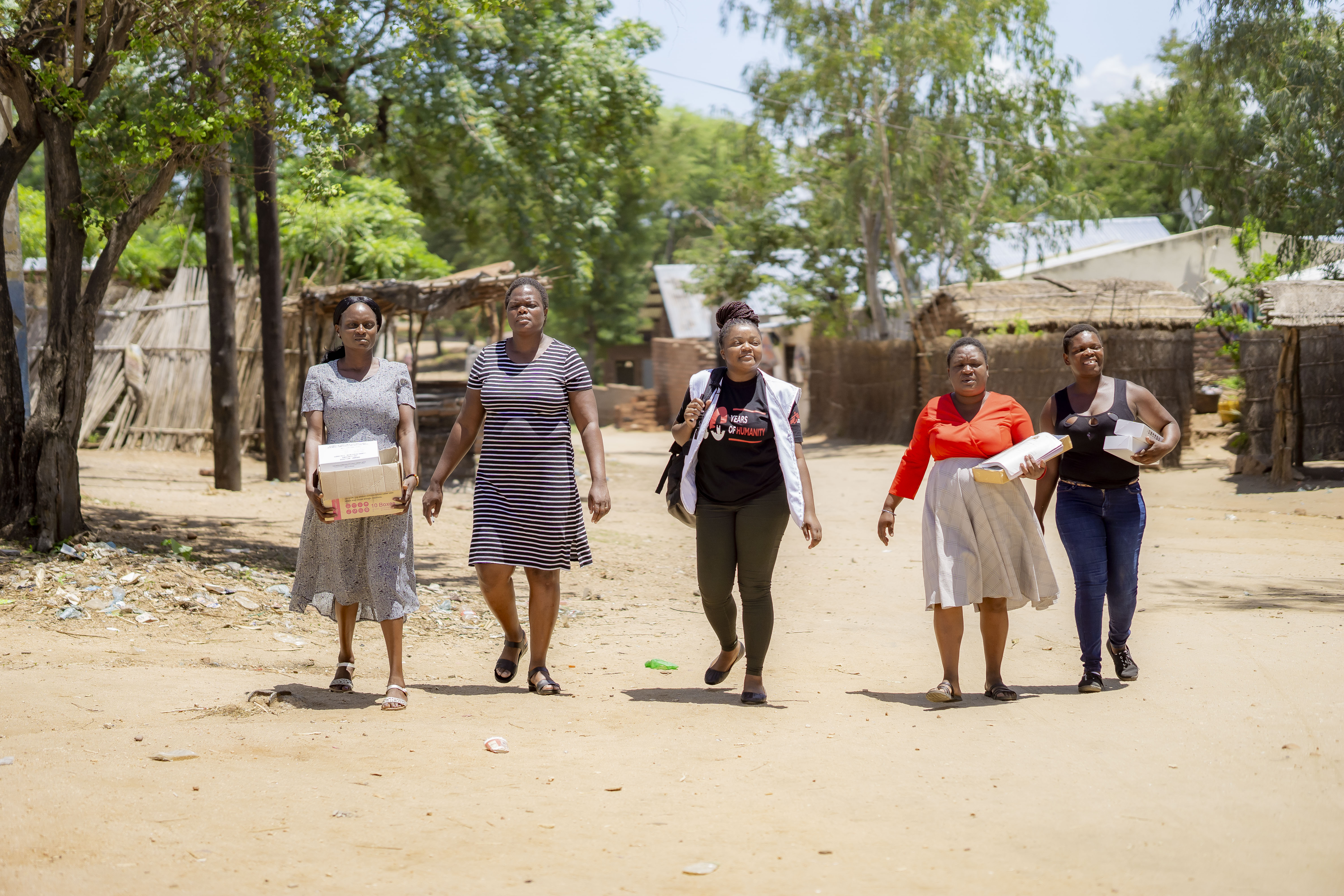 msf_community_engagement_technical_capacity_manager_gloria_mwambazi_centre_accompanies_msf_midwife_christine_second_from_left_and_members_of_tikondane_community-based_organisation_from_left_to_right_cecilia.jpg
